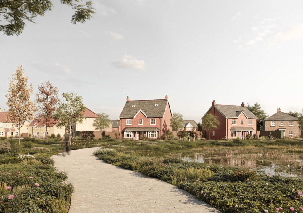A peaceful lakeside setting at Gleneagles Drive with pathways, planting, and views of red-brick homes overlooking the water, offering a sense of open space and nature woven into the development.