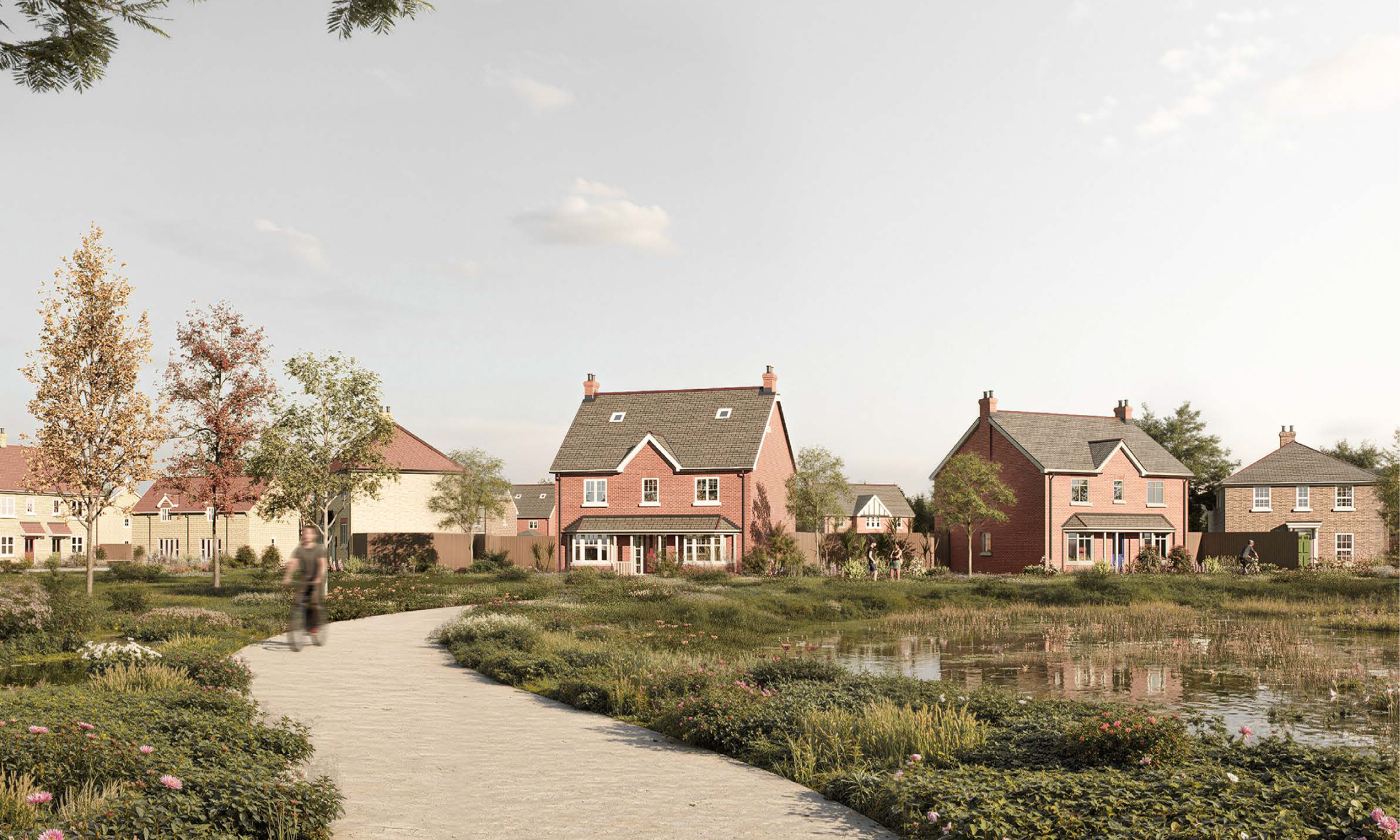 A peaceful lakeside setting at Gleneagles Drive with pathways, planting, and views of red-brick homes overlooking the water, offering a sense of open space and nature woven into the development.
