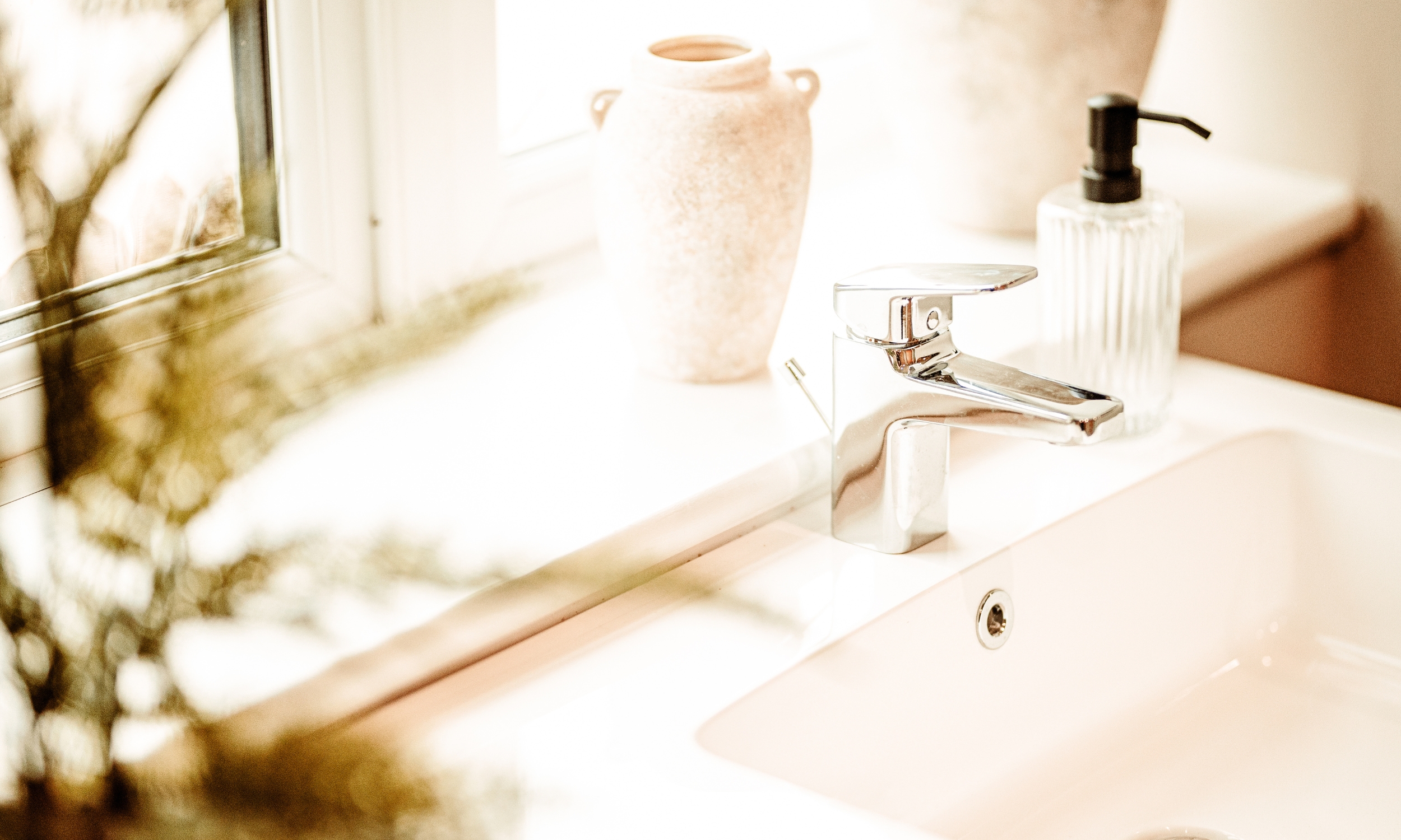 Close-up of a bathroom sink with chrome fittings and soft natural light - showcasing Broadgate’s attention to quality finishes at The Furlongs.