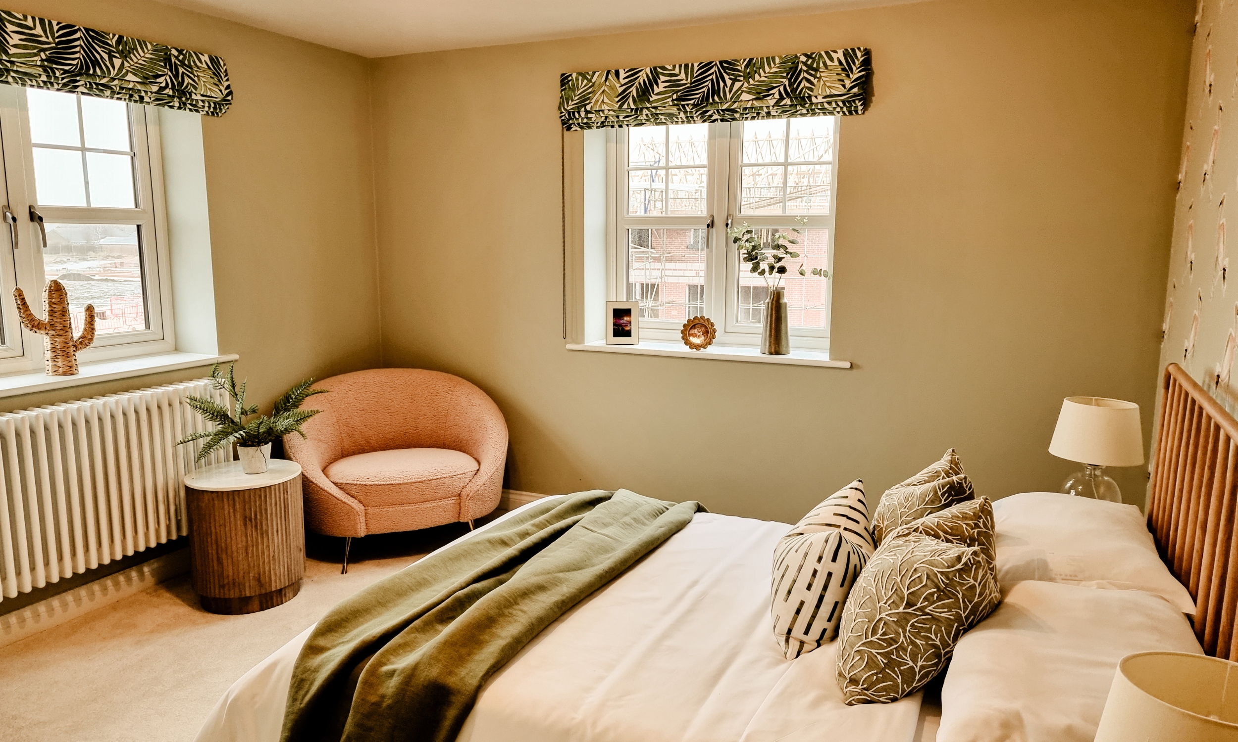 Warm, inviting bedroom with leafy green accents, natural light, and soft textures - a perfect retreat in a Broadgate home.