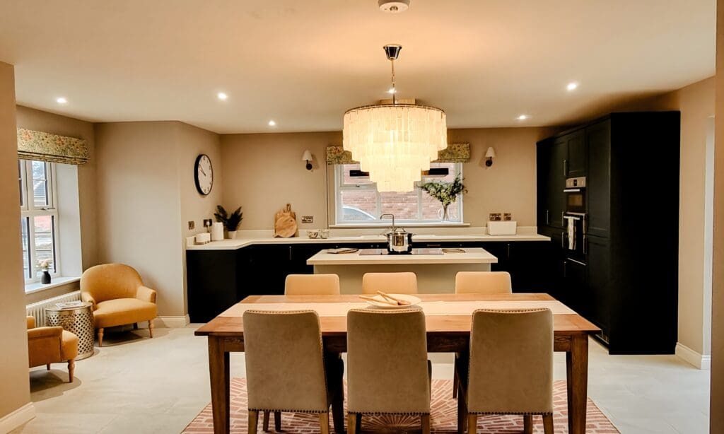 Spacious kitchen and dining area with a large chandelier, neutral walls, and natural light - blending elegance and practicality in a Broadgate home.
