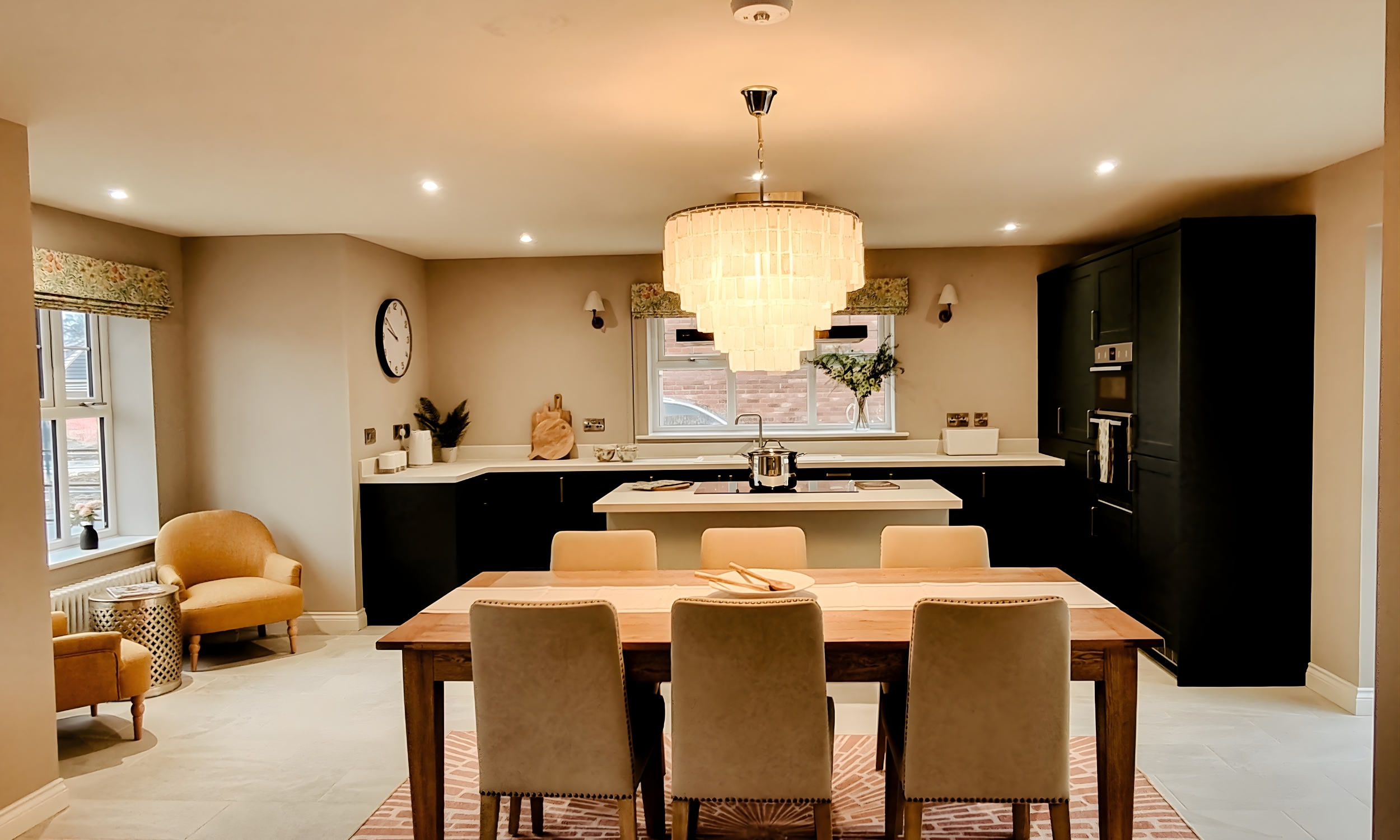 Spacious kitchen and dining area with a large chandelier, neutral walls, and natural light - blending elegance and practicality in a Broadgate home.