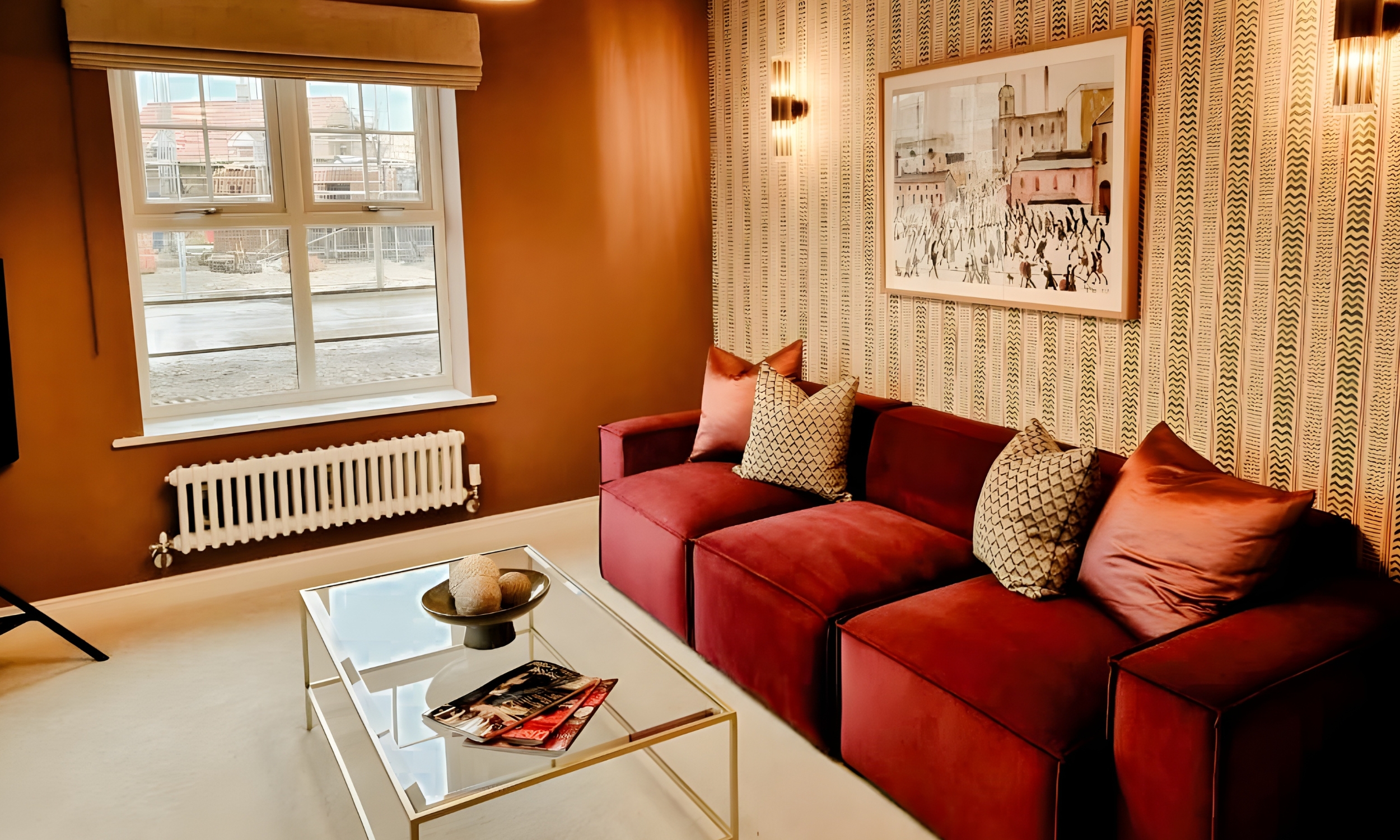 Inviting living room with green velvet sofas, soft neutral tones, and natural light streaming through French doors - a welcoming family space at The Furlongs, Holland Park.
