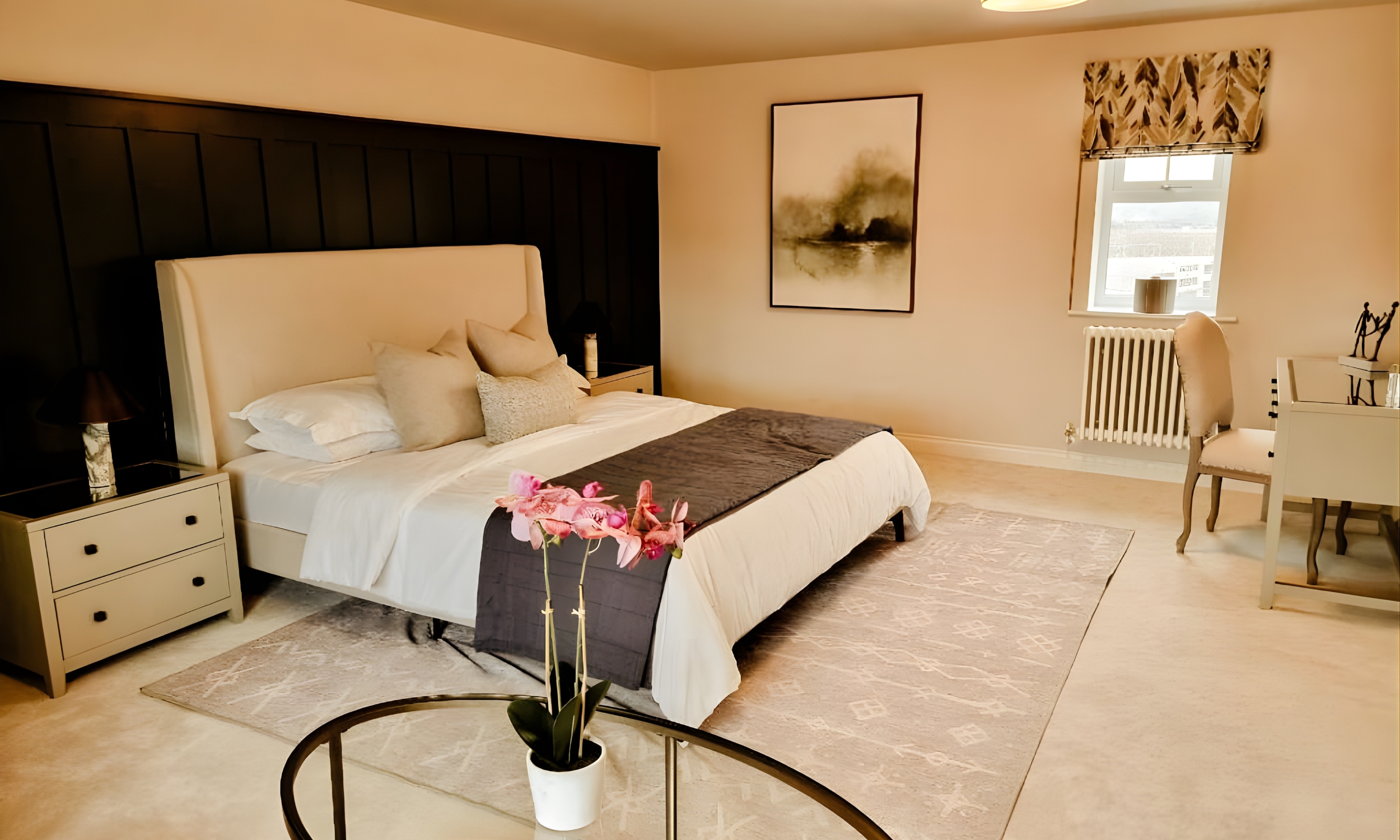 A serene master bedroom with an upholstered headboard, soft layered bedding, and a dark feature wall - designed for calm and comfort at The Furlongs, Holland Park.