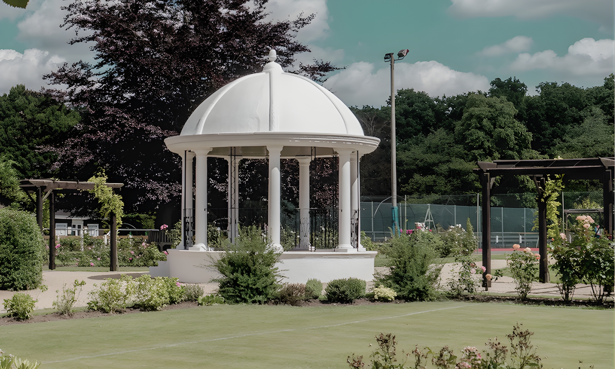 The ornamental bandstand and gardens at Jubilee Park in Woodhall Spa, surrounded by mature trees, pathways and planting, highlighting the area’s peaceful outdoor spaces.