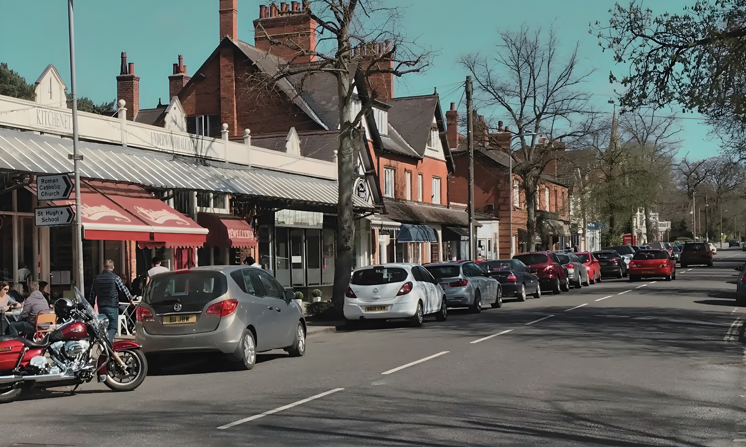 Woodhall Spa high street, featuring cafés, independent shops and people enjoying the village centre, capturing the friendly, relaxed atmosphere of the local community.
